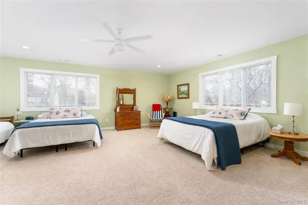 a spacious bedroom with a bed and a large window