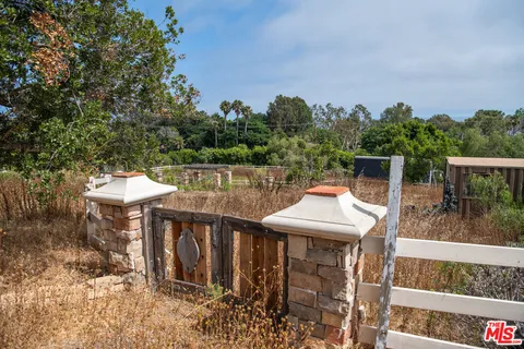 a balcony with wooden floor and outdoor seating