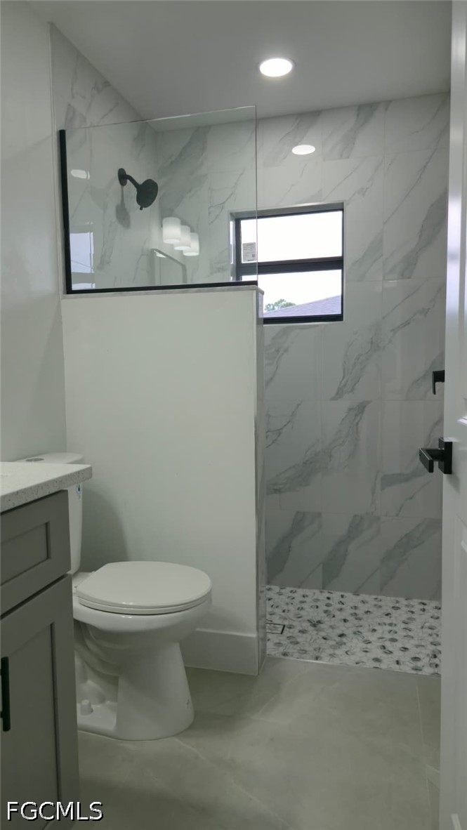 4429 26th Street Southwest Lehigh Acres, FL 33973 - Photo 13 of 16 a bathroom with a toilet and a shower