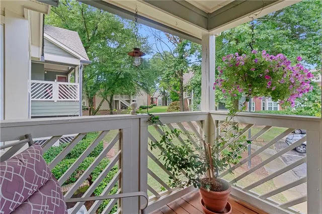 a view of a balcony with flower plants