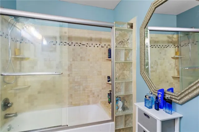 a bathroom with a shower and a bath tub