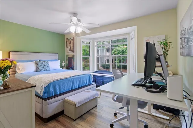 a bedroom with a bed and a large window