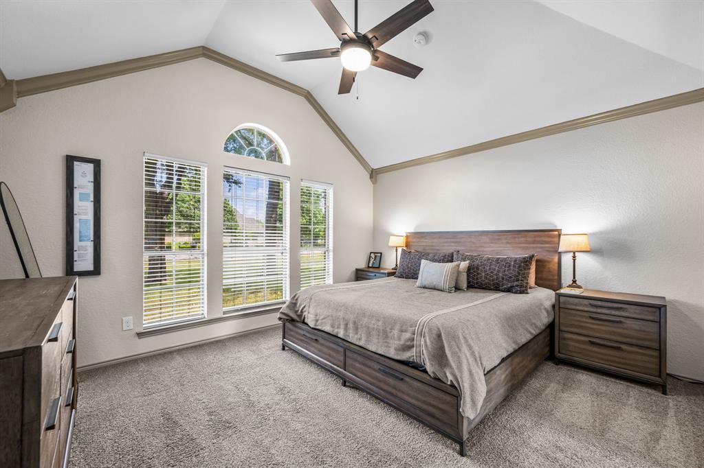 9624 Wells Road Wylie, TX 75098 - Photo 11 of 25 a bedroom with a large bed and a chandelier
