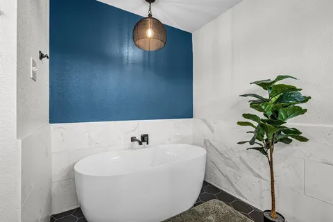 a white bath tub sitting in a bathroom
