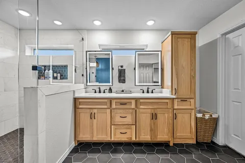 a bathroom with a sink a mirror and a shower