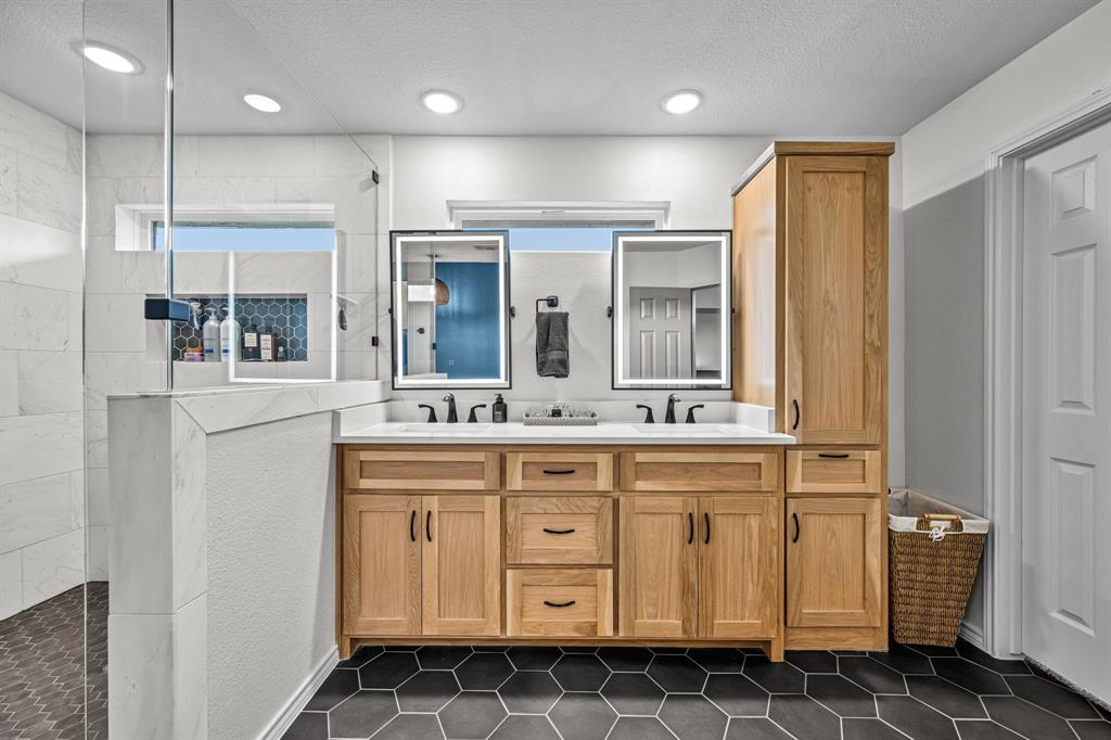 9624 Wells Road Wylie, TX 75098 - Photo 14 of 25 a bathroom with a sink a mirror and a shower