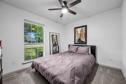 a large bed sitting in a bedroom next to a window