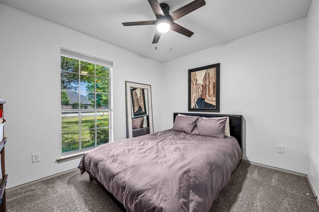 9624 Wells Road Wylie, TX 75098 - Photo 16 of 25 a large bed sitting in a bedroom next to a window