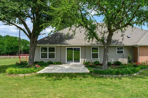 a front view of a house with a garden and porch