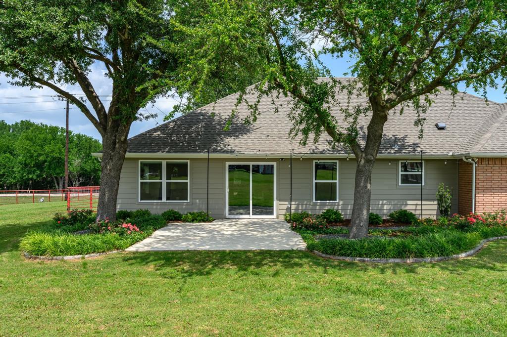 9624 Wells Road Wylie, TX 75098 - Photo 18 of 25 a front view of a house with a garden and porch