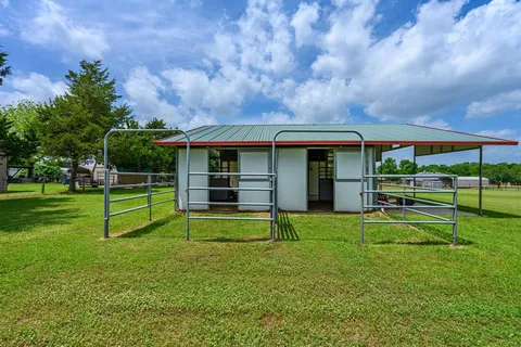 a view of a house with a yard and sitting area