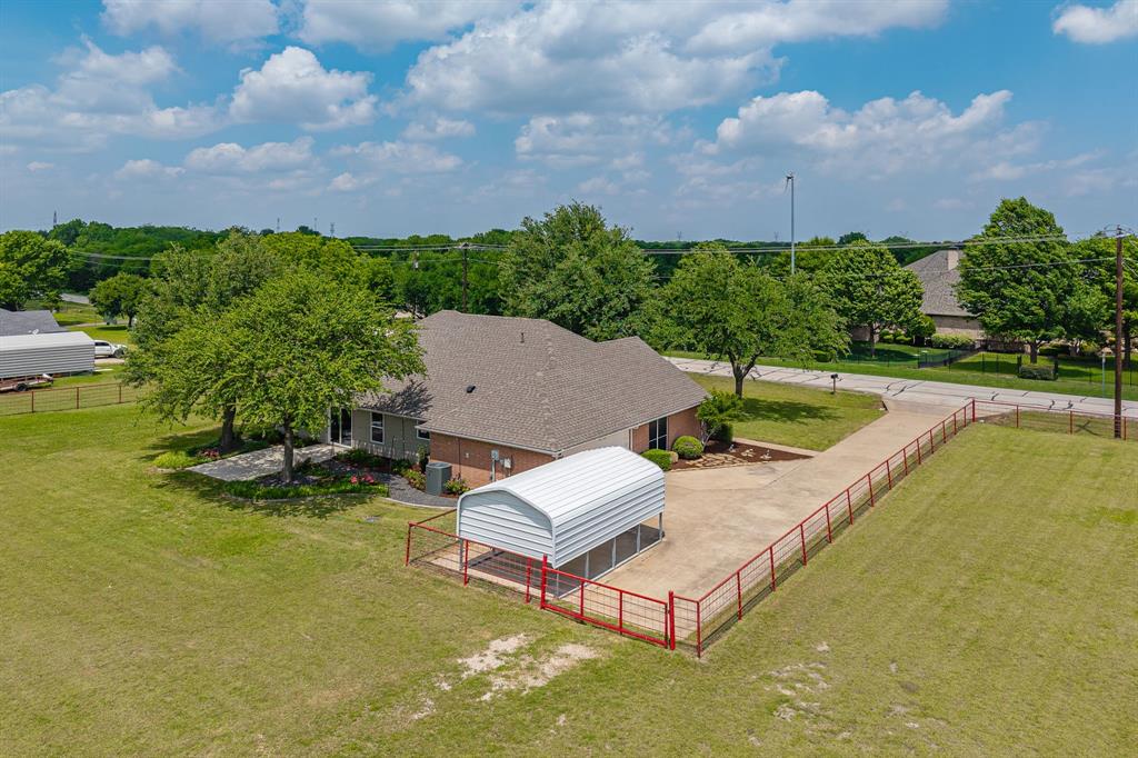 9624 Wells Road Wylie, TX 75098 - Photo 24 of 25 a view of a swimming pool and lounge chairs in back yard of the house