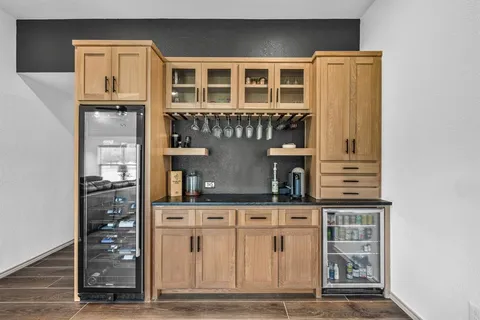 a kitchen with stainless steel appliances granite countertop a refrigerator and cabinets
