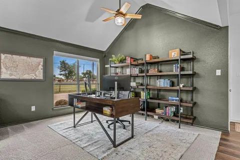 a work room with furniture and a bookshelf
