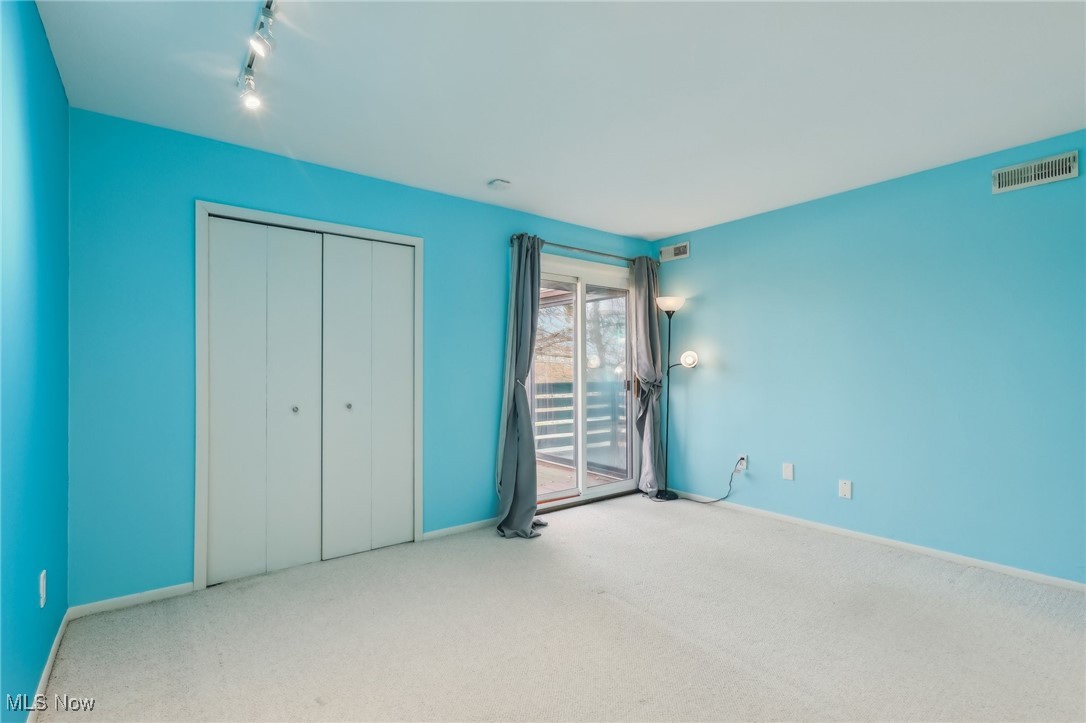 3484 Mayfield Road, Unit 3426 Cleveland Heights, OH 44118 - Photo 22 of 33 Unfurnished bedroom with a closet, carpet floors, access to outside, visible vents, and track lighting