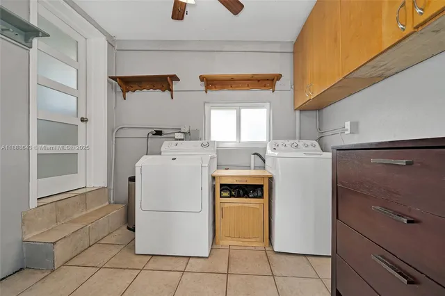 a view of a hallway with wooden floor and a bathroom