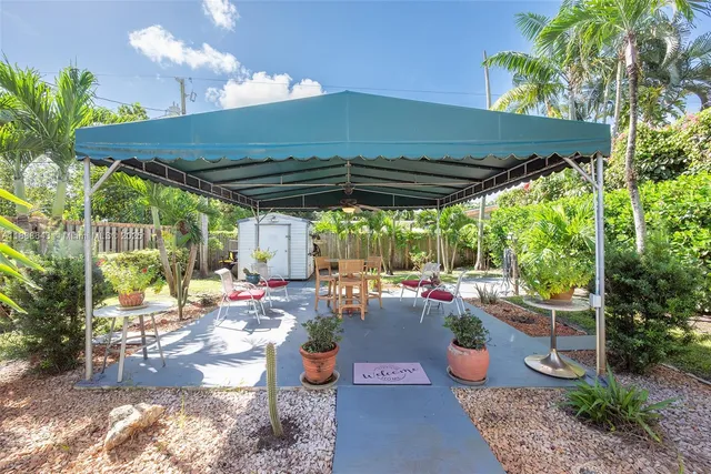 a front view of a house with garden and patio