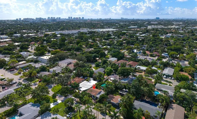an aerial view of a house with a yard and lake view