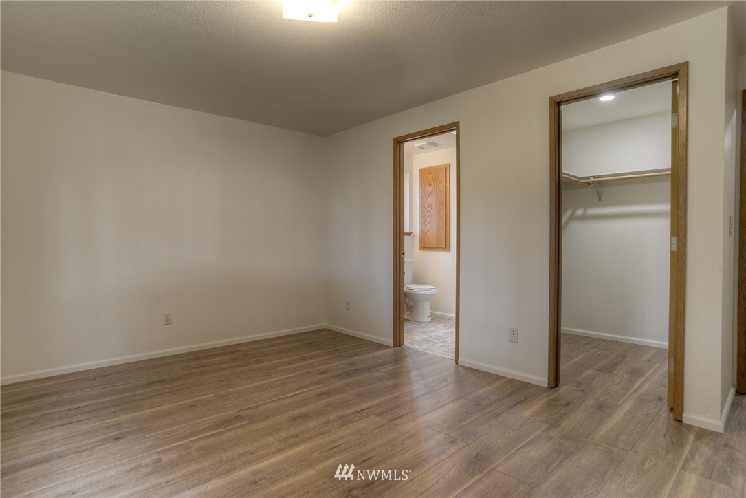 8505 Foreign Lane Southwest Rochester, WA 98579 - Photo 14 of 22 a view of an empty room with wooden floor & closet