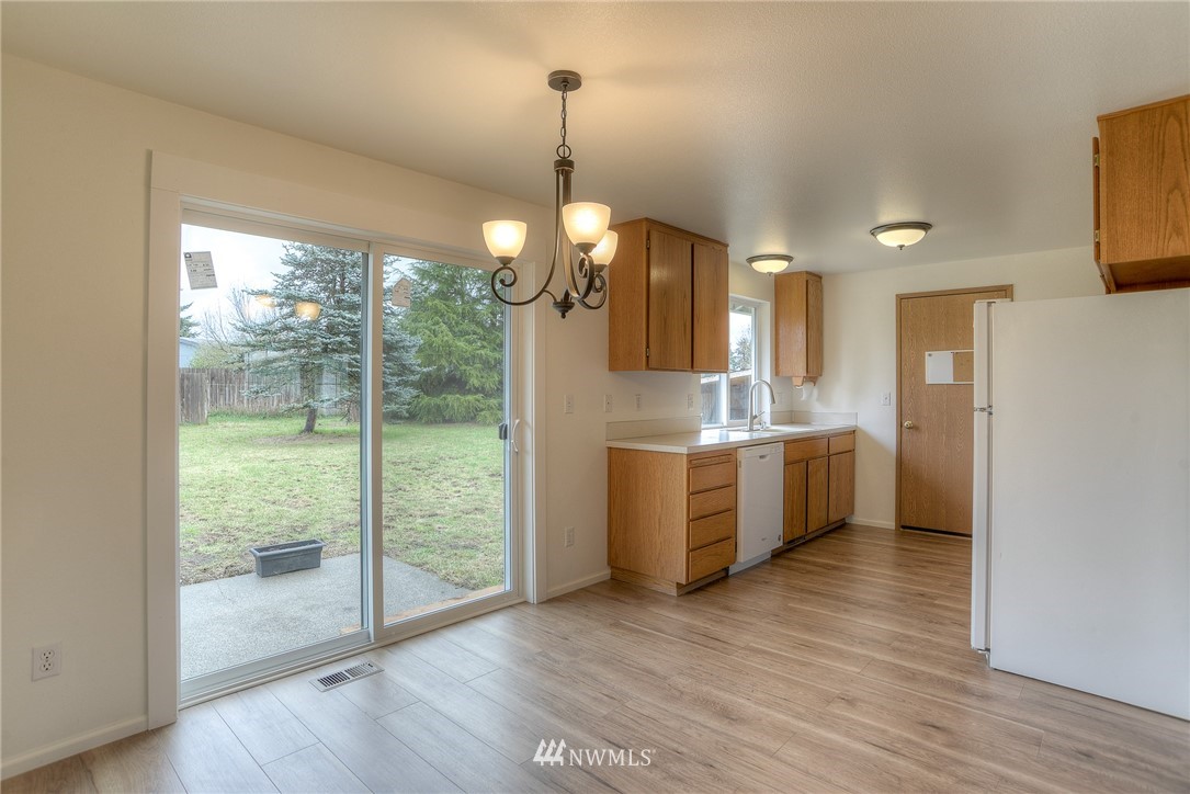 8505 Foreign Lane Southwest Rochester, WA 98579 - Photo 8 of 22 a kitchen with a wooden floor and a large window