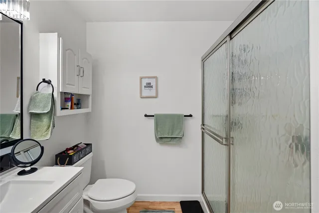 a bathroom with a toilet a sink and shower