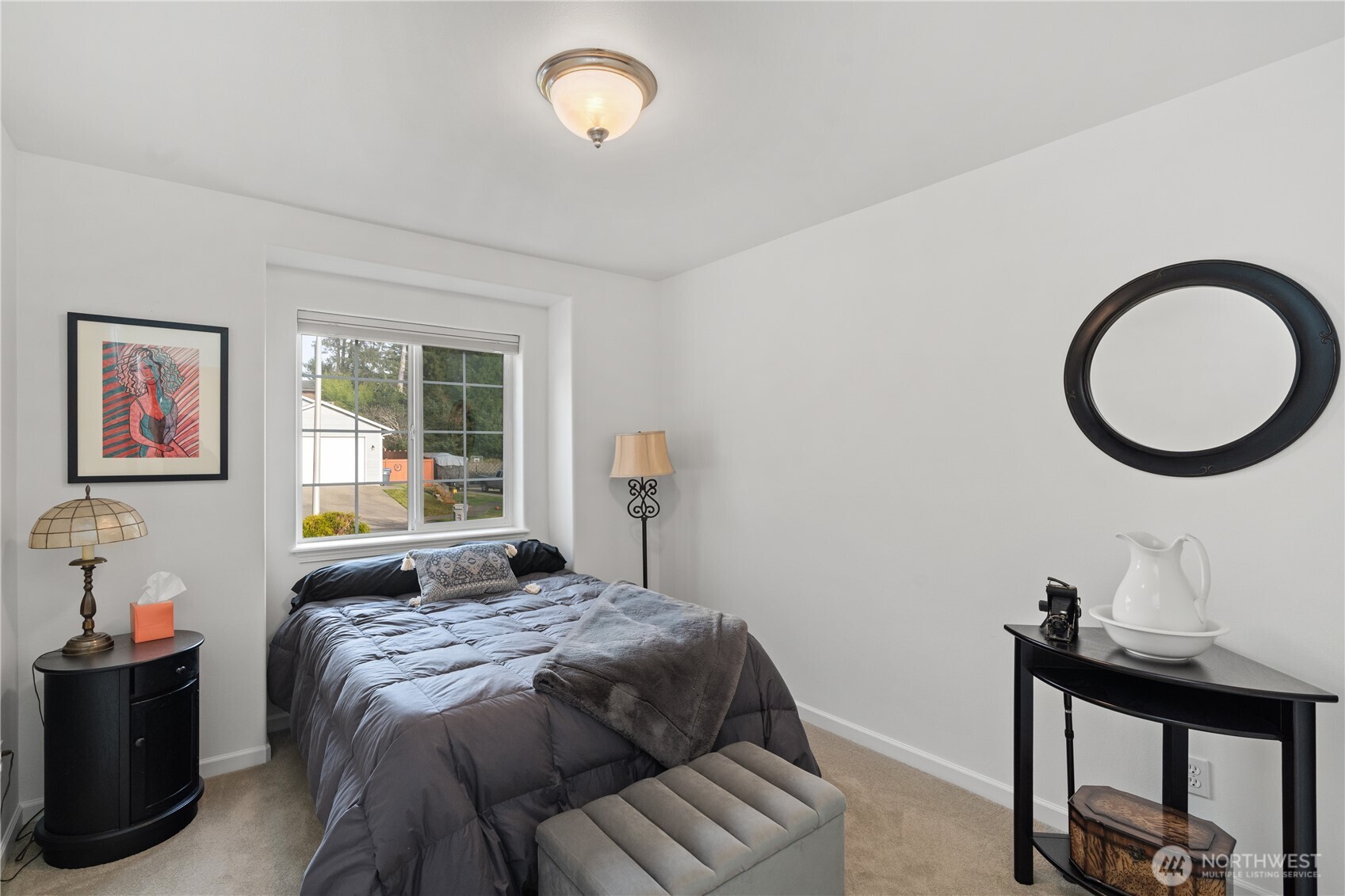 405 Andrews Avenue Cosmopolis, WA 98537 - Photo 15 of 34 a bedroom with a bed and a lamp next to a window