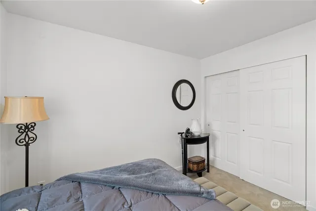 a view of a room with a hanging light and hardwood