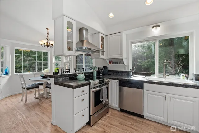a kitchen with stainless steel appliances granite countertop a stove and a sink