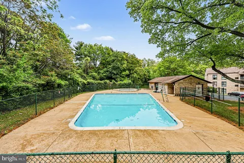 a view of a backyard and swimming pool