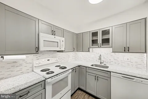 a kitchen with a sink stove and cabinets