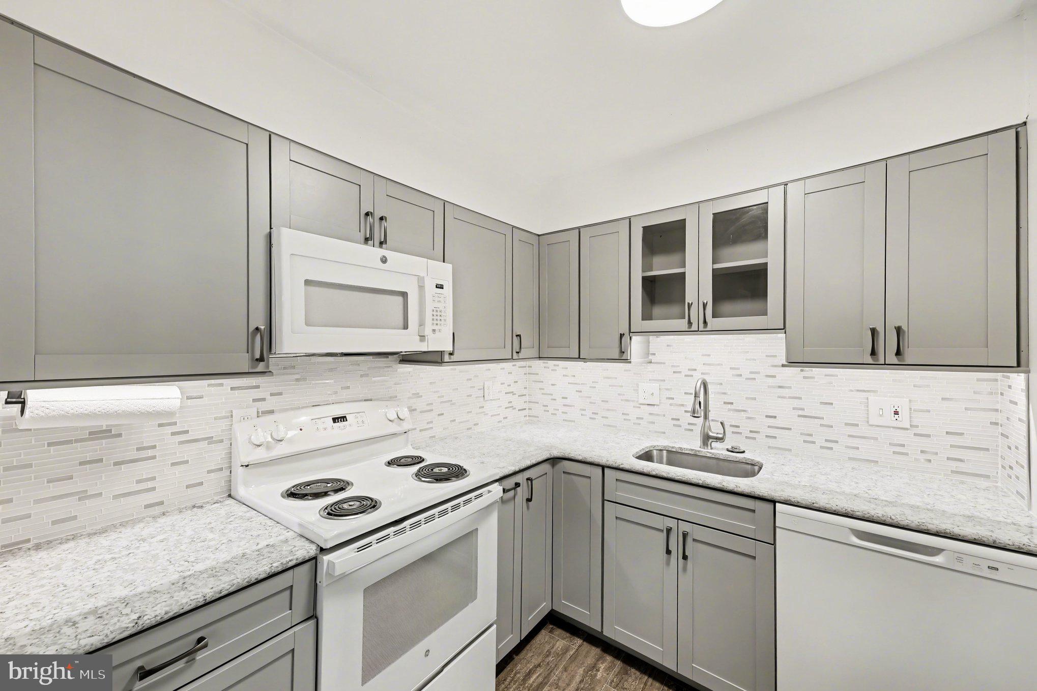 6141 Edsall Road, Unit L Alexandria, VA 22304 - Photo 7 of 18 a kitchen with a sink stove and cabinets