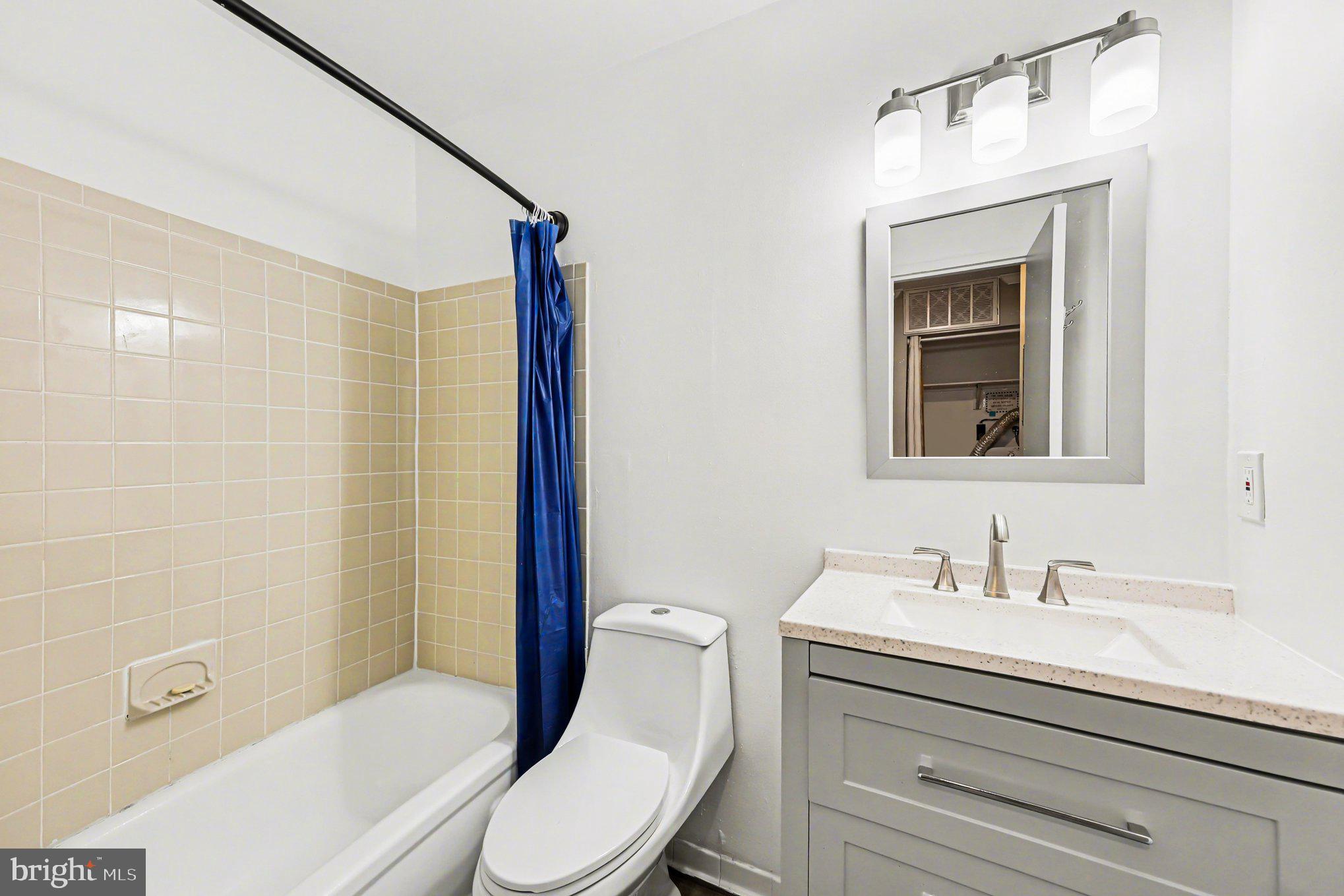 6141 Edsall Road, Unit L Alexandria, VA 22304 - Photo 10 of 18 a bathroom with a sink a toilet and shower