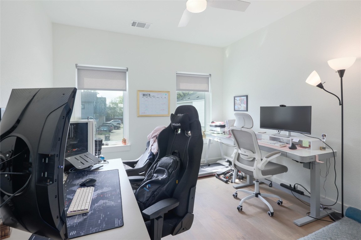 5820 Sutherlin Road, Unit 17 Austin, TX 78723 - Photo 11 of 15 a view of a workspace with furniture and a flat screen tv