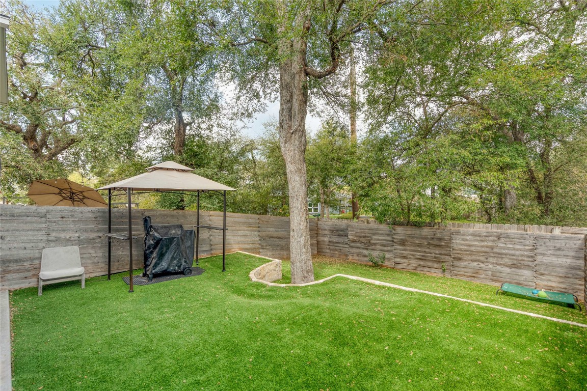 5820 Sutherlin Road, Unit 17 Austin, TX 78723 - Photo 14 of 15 a view of a wooden deck and a yard
