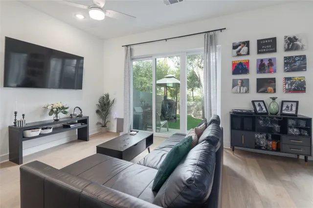 a living room with furniture cabinets and a flat screen tv