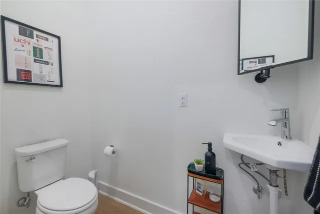 a bathroom with a sink a toilet and a mirror