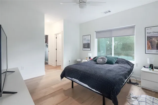 a bed sitting in a bedroom next to a window