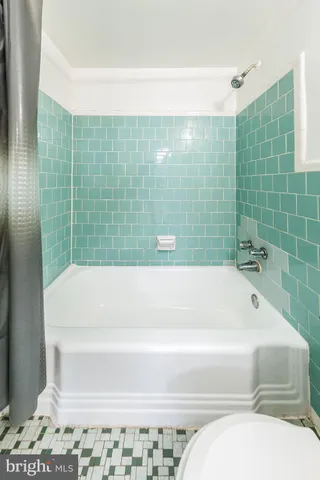 a bathroom with a bathtub and shower