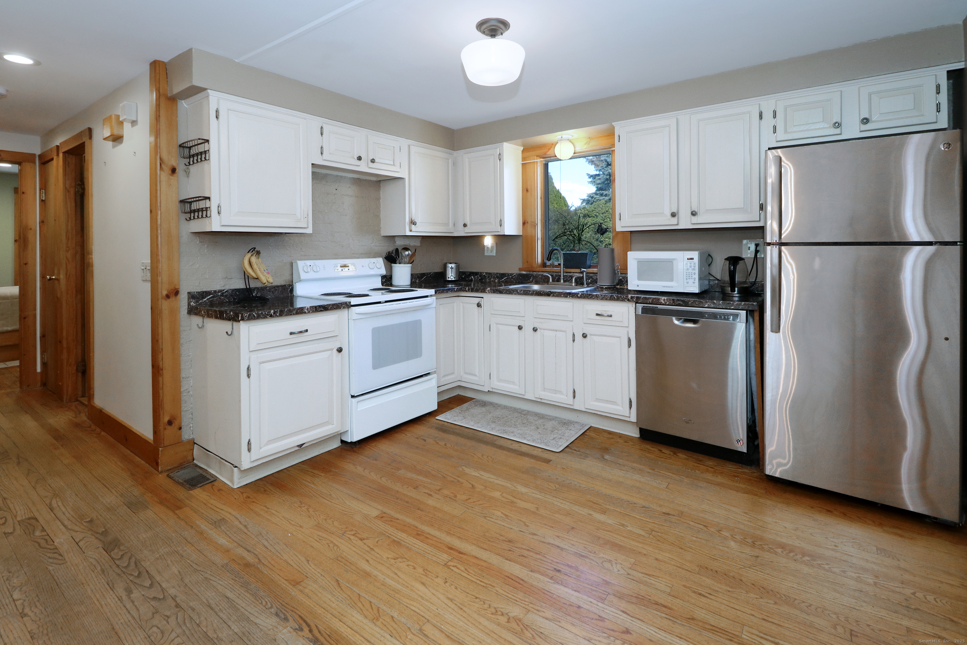 28 Stillson Place Fairfield, CT 06824 - Photo 11 of 28 a kitchen with stainless steel appliances granite countertop a refrigerator sink and cabinets
