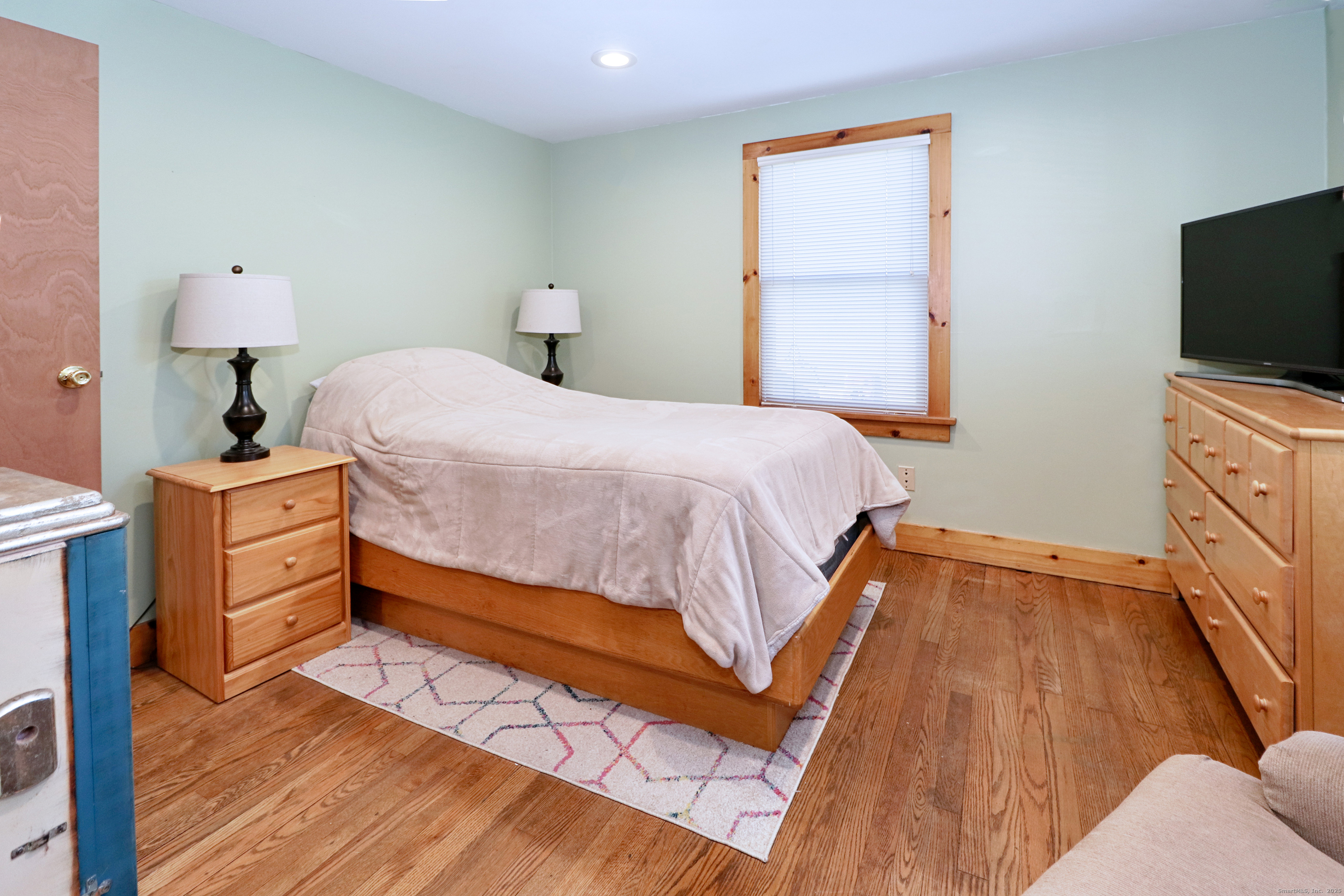 28 Stillson Place Fairfield, CT 06824 - Photo 14 of 28 a bedroom with a bed and a flat screen tv