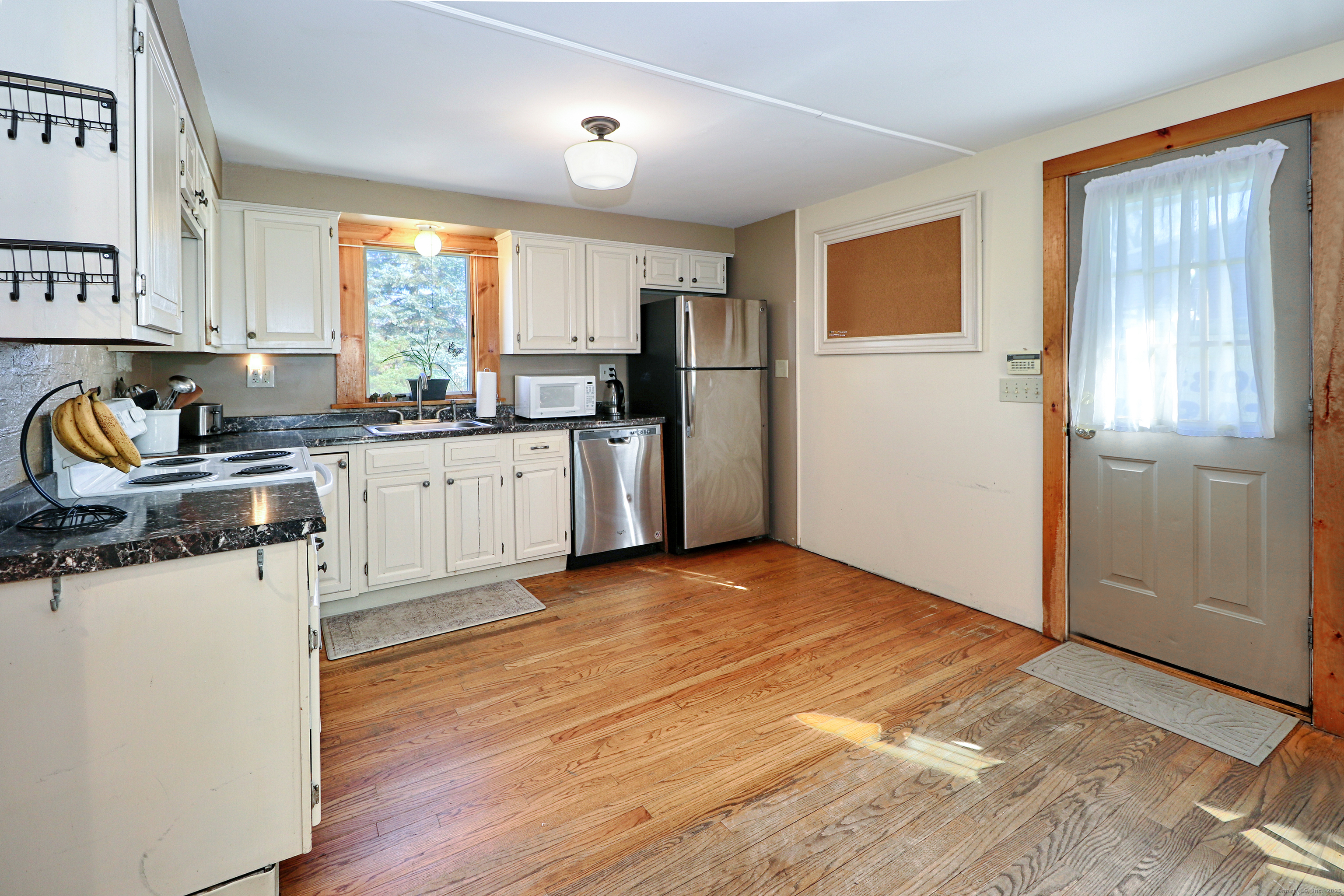 28 Stillson Place Fairfield, CT 06824 - Photo 10 of 28 a kitchen with granite countertop a refrigerator a sink a stove and white cabinets