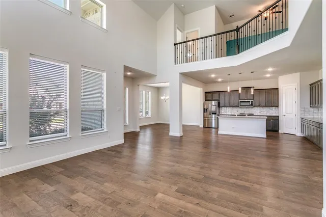 a view of an entryway with kitchen and windows