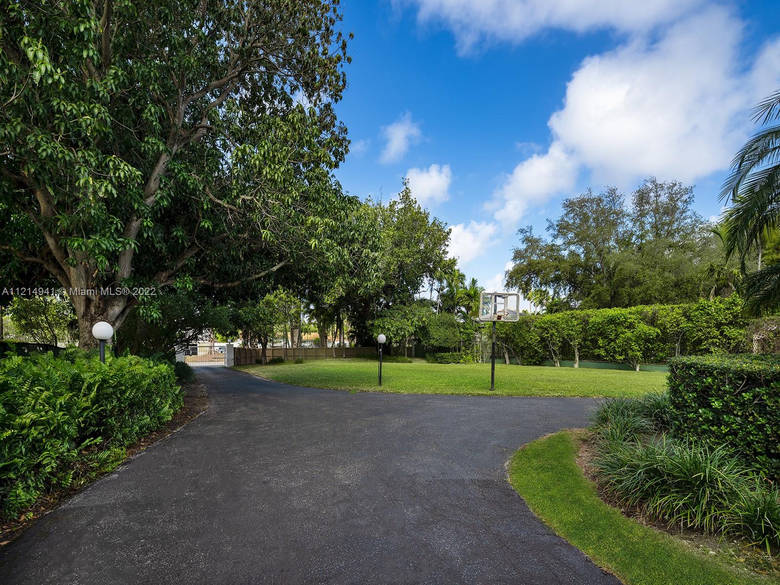 4525 Pine Tree Drive Miami Beach, FL 33140 - Photo 15 of 19 a view of a park with large trees