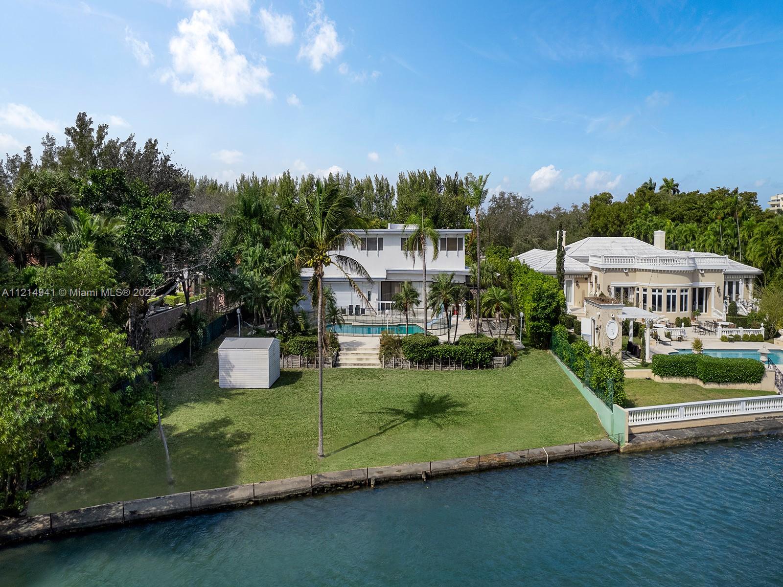 4525 Pine Tree Drive Miami Beach, FL 33140 - Photo 8 of 19 a view of a house with a big yard and large trees