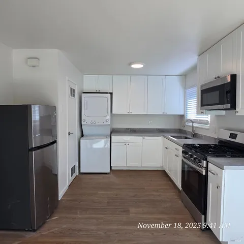 a kitchen with a refrigerator stove and microwave