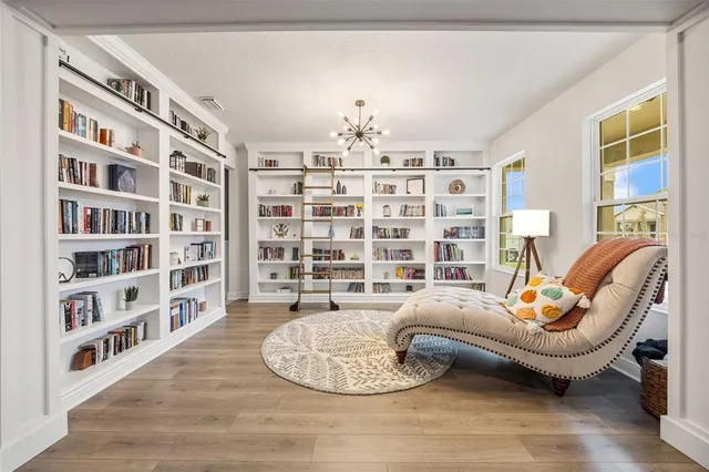 a view of a livingroom with furniture hardwood floor and a ceiling fan