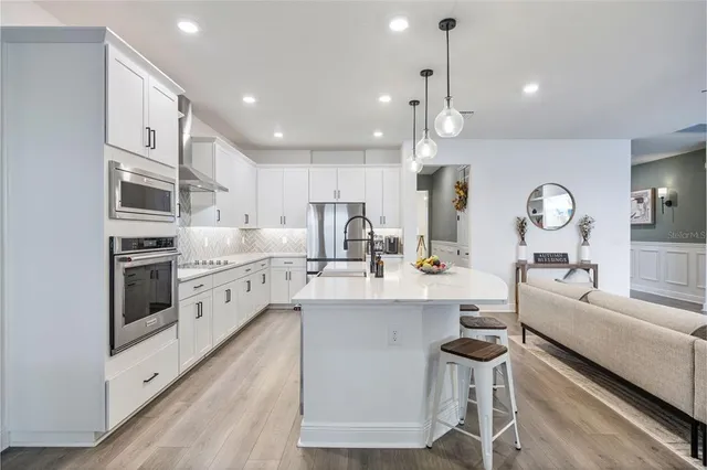 a spacious bedroom with a bed and a chandelier