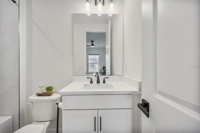 an aerial view of a house with garden space seating area and car parked