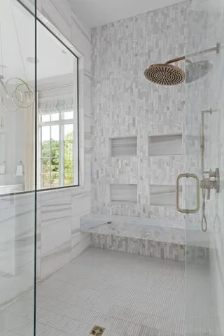 a bathroom with a tub sink and mirror