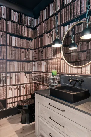 a living room with furniture a flat screen tv and kitchen view